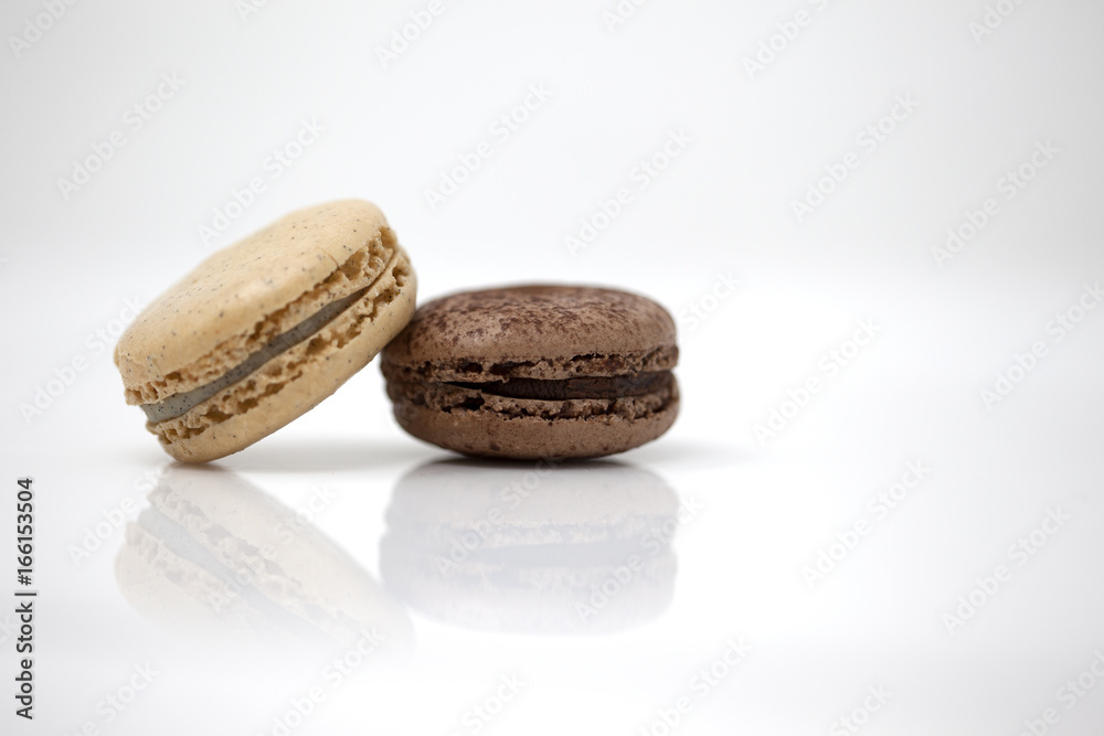 Light brown macaron with a dark brown macaron Light brown macaron with a dark brown macaron