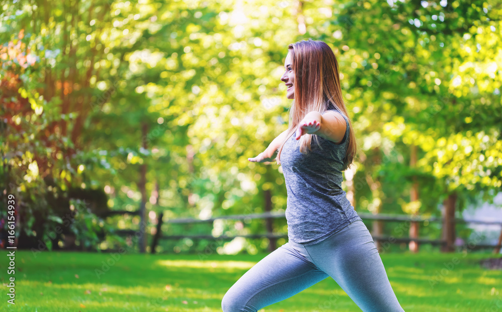 Fit healthy young woman doing stretches outdoors