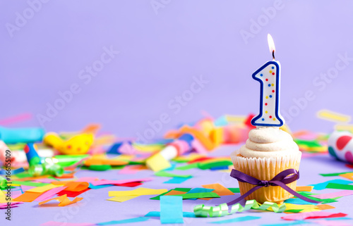 First birthday celebration theme with cupcake candle and party accessories