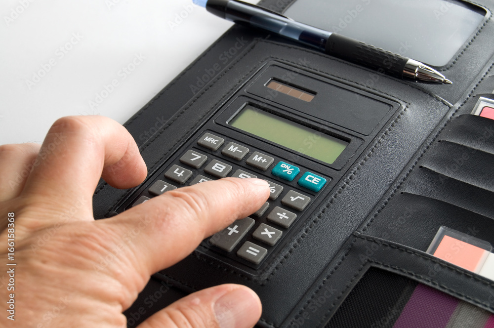 Person's Hand using a Calculator Person's Hand using a Calculator
