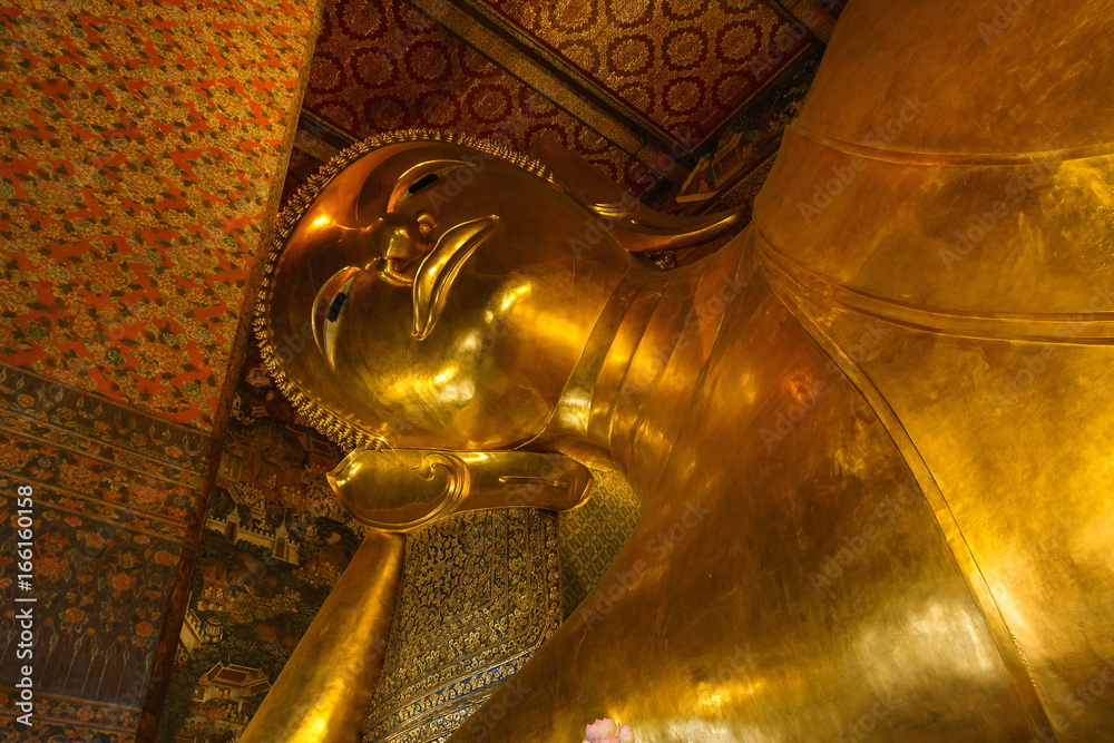 Buddha,The big golden reclining buddha Wat Phra Chetuphon (locally known as Wat Pho) is famed for the massive ‘Reclining Buddha’ it houses.Bangkok, Thailand.