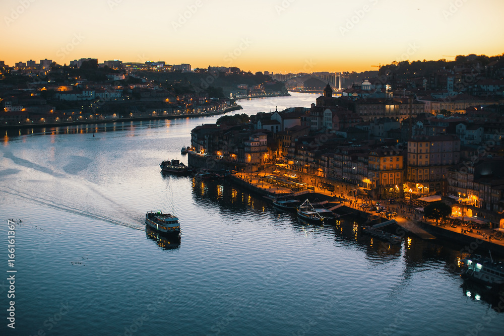 Douro river and Ribeira from Dom Luis I bridge at night time, Porto, Portugal.