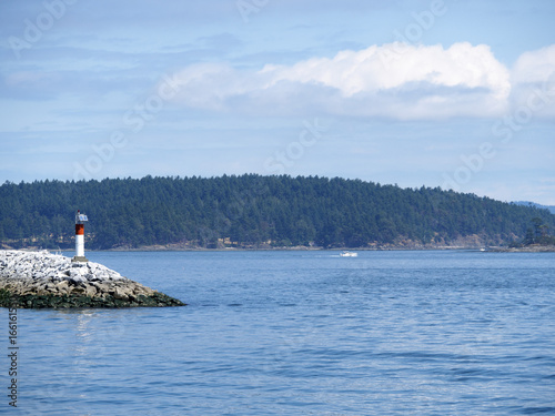 Lighthouse on the rocks on a sunny day  © Katherine BYC