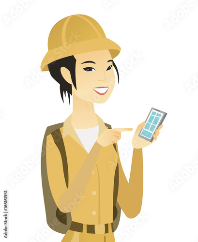 Young asian traveler holding a mobile phone.