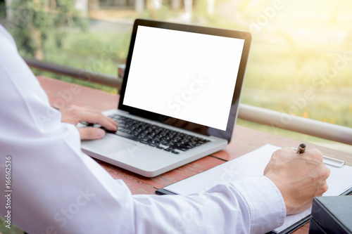 Image of businessman working with laptop, tablet and financial document data graph on table in outdoor office, finance,investment, business concept