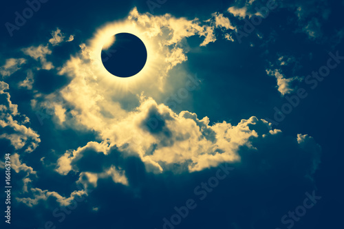 Scientific natural phenomenon. Total solar eclipse with diamond ring effect glowing on sky.