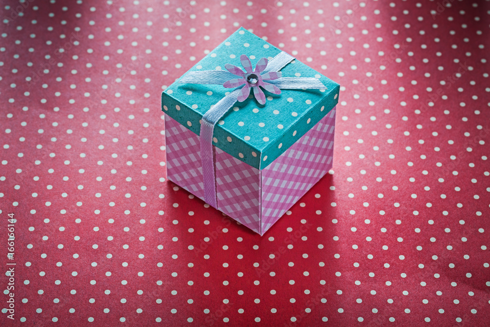 Present box on red polka-dot table cloth celebrations concept