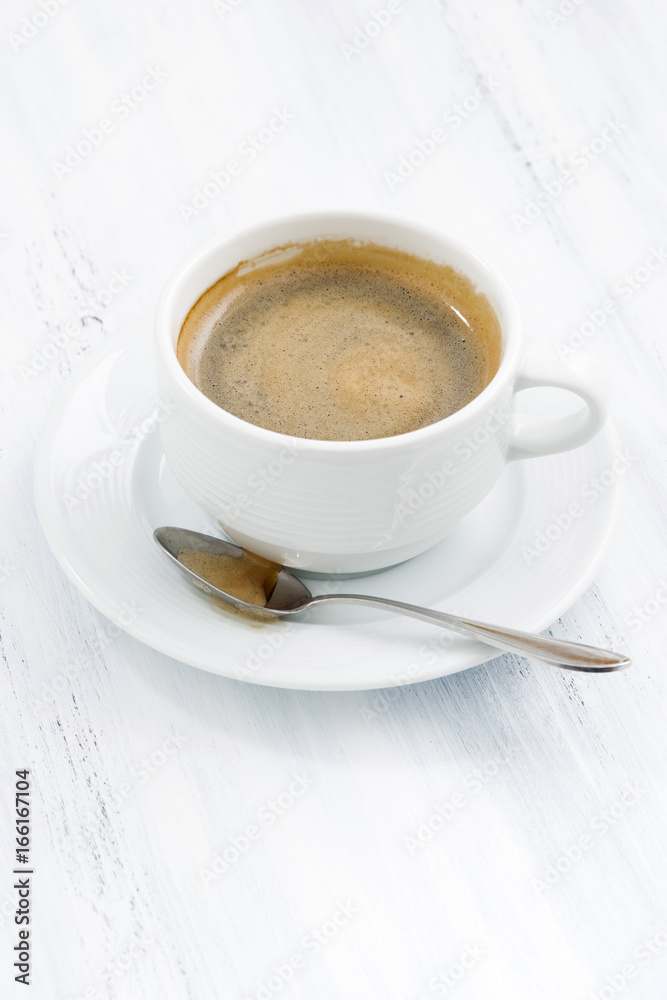 cup of black coffee on white wooden table, vertical cup of black coffee on white wooden table, vertical