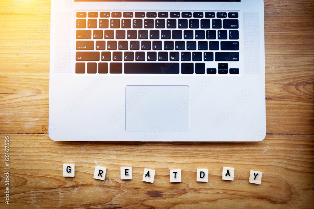 Happy people at workspace concept. Great day text on a wooden background in front of laptop notebook on office desk. work with a good workmate. film effect. Happy people at workspace concept. Great day text on a wooden background in front of laptop notebook on office desk. work with a good workmate. film effect.