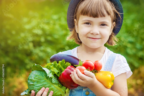 Child and vegetables. Selective focus.   photo