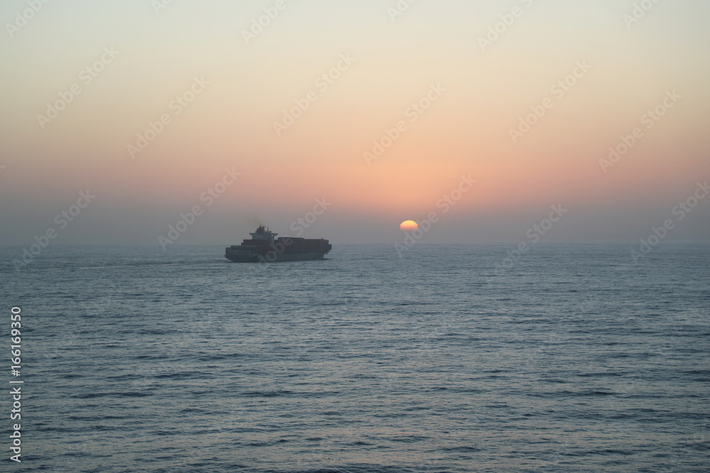 Sunset and cargo ship