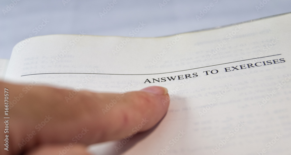 Obraz premium answers to exercises on a school and university textbook with finger