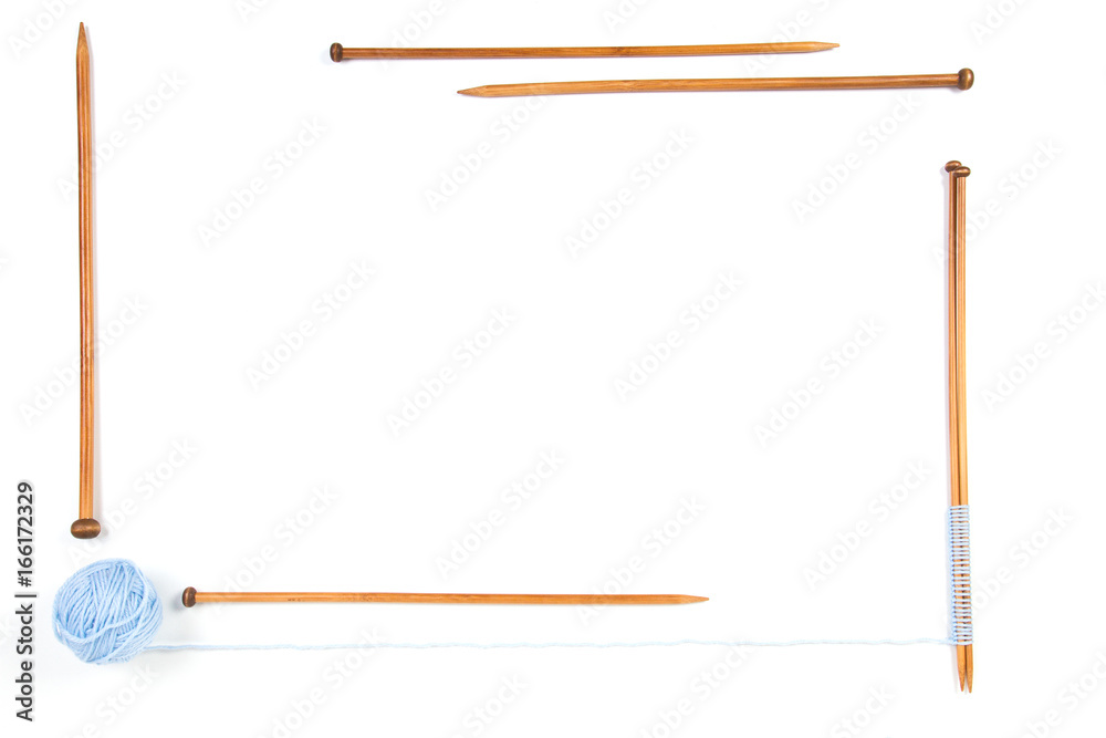 Knitting needles and blue yarn ball frame on white background Knitting needles and blue yarn ball frame on white background