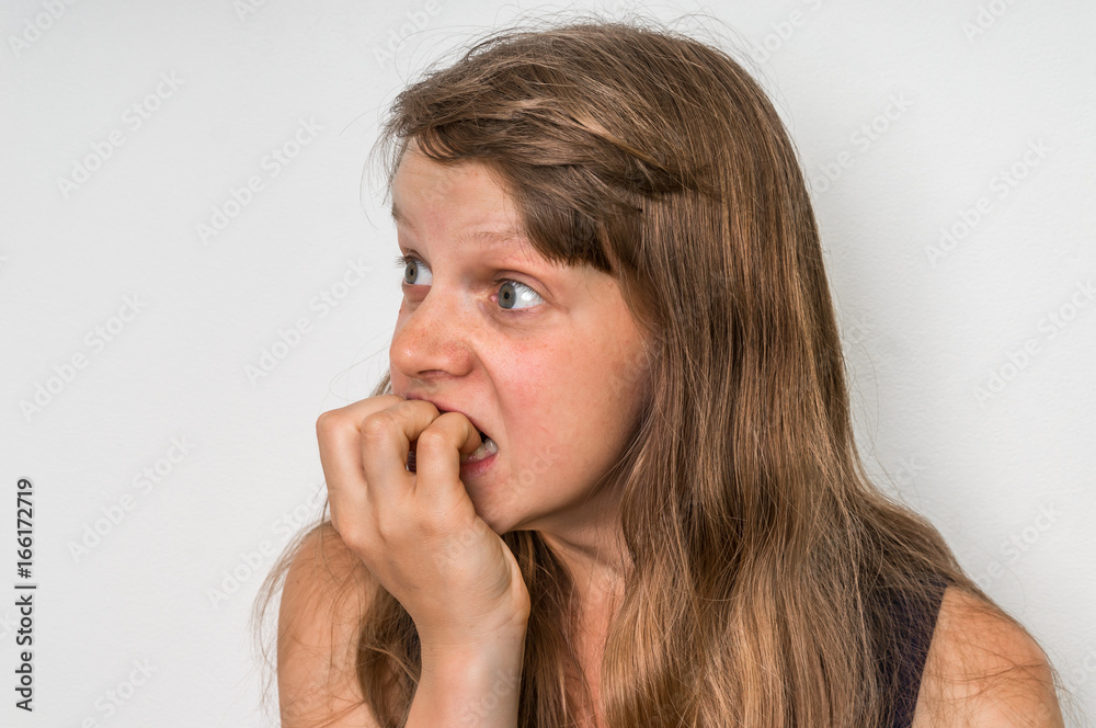 Nervous woman biting her nails Nervous woman biting her nails