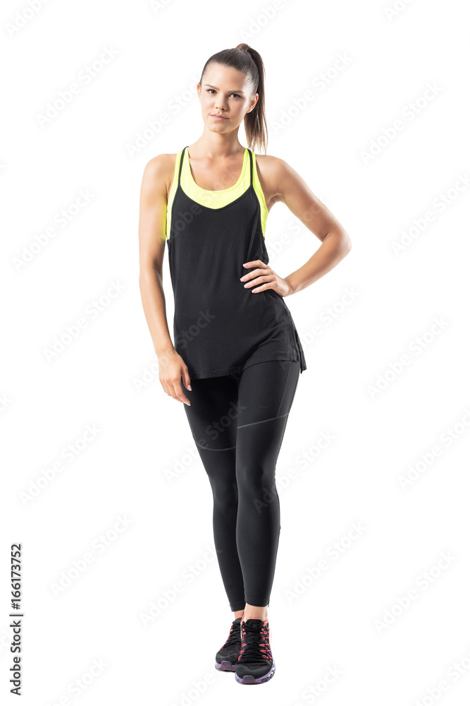 Professional female jogging athlete in sportswear posing at camera. Full body length portrait isolated on white background. Professional female jogging athlete in sportswear posing at camera. Full body length portrait isolated on white background.