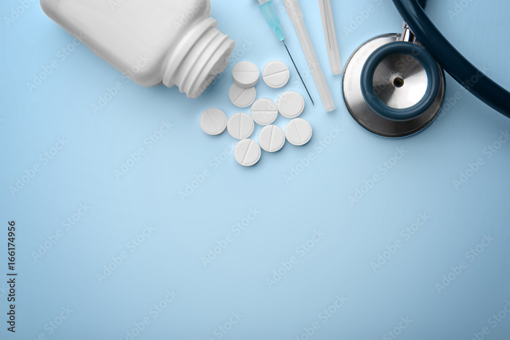 Health care concept. Composition with pills and medical stuff on blue background Health care concept. Composition with pills and medical stuff on blue background