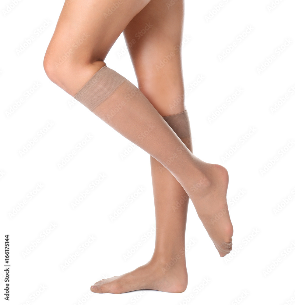 Legs of beautiful young woman in knee socks on white background Legs of beautiful young woman in knee socks on white background