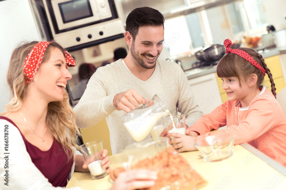 Happy family having breakfast in kitchen Happy family having breakfast in kitchen