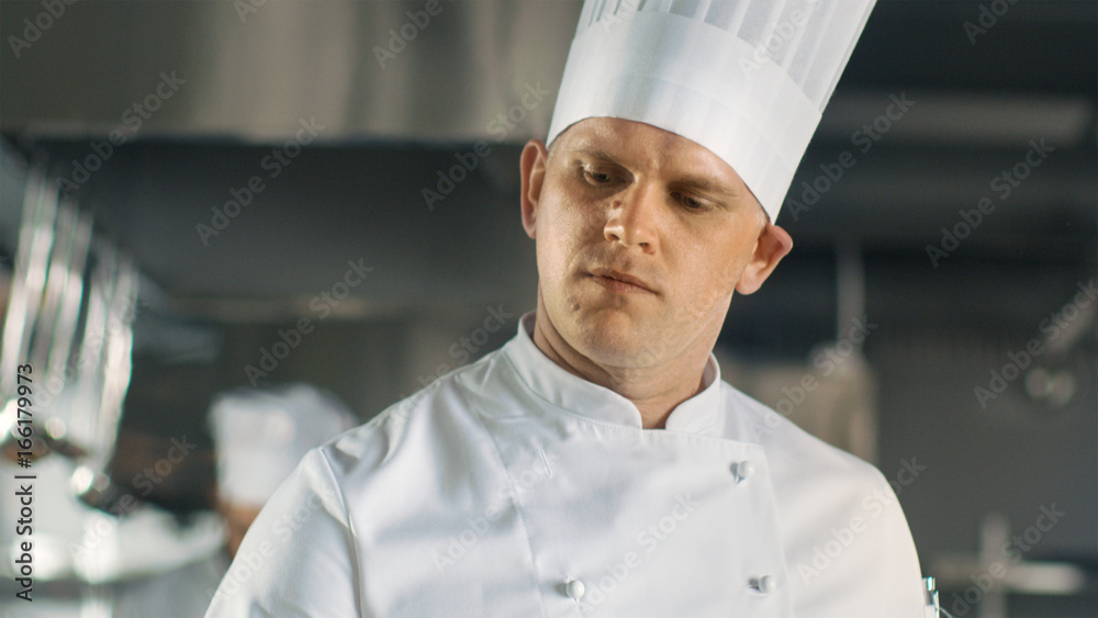 Close-up of a Famous Chef Concentrated on Cooking.