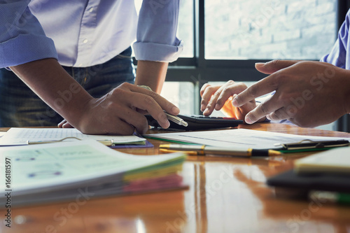 Administrator business man financial inspector and secretary making report, calculating or checking balance.