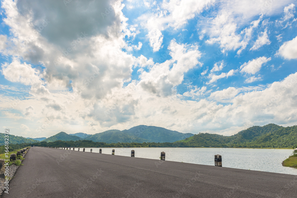 Long road travel with landscape of mountain with sky and cloud at Huay Prue reservior, Thailand