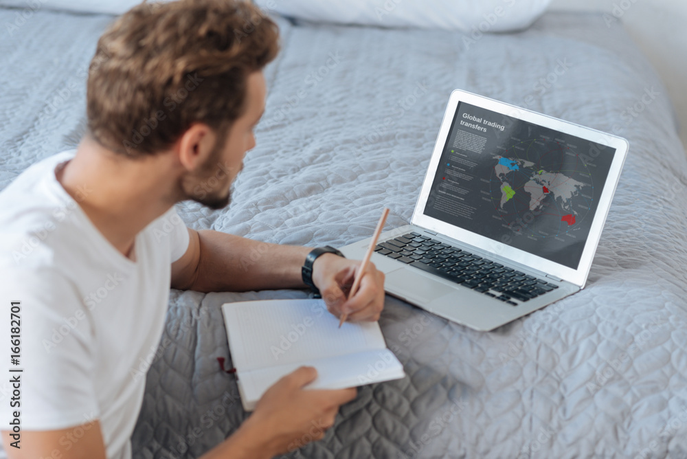 Serious man analyzing the diagram on the map Serious man analyzing the diagram on the map