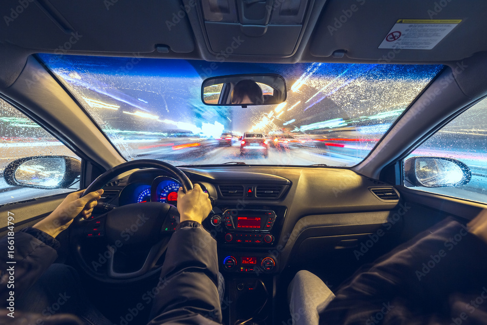 Two man in car moves at fast speed at night. Two man in car moves at fast speed at night.