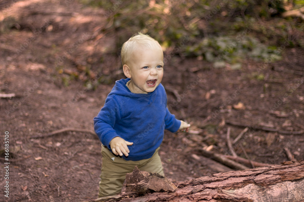 Cute lauginhg baby boy in the autumn forest Cute lauginhg baby boy in the autumn forest