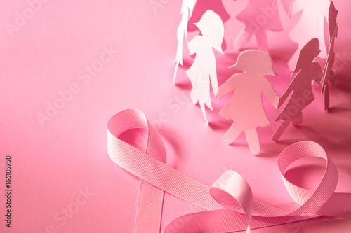 The Sweet pink ribbon shape with girl paper doll on pink background for Breast Cancer Awareness symbol to promote in october month campaign