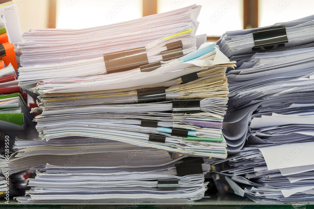 Close up of business documents stack on desk , report papers stack Close up of business documents stack on desk , report papers stack