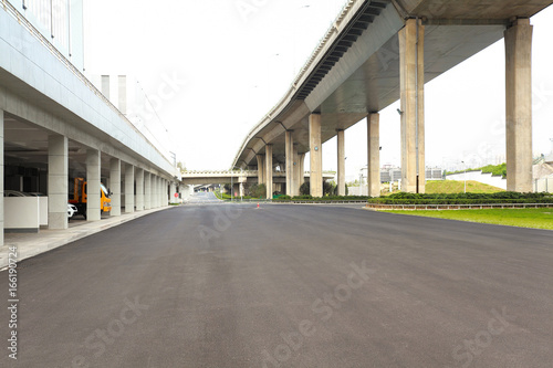 Empty road surface floor with city bridge