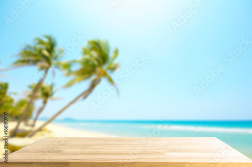Empty Wooden table for display product and blurry beautiful beach in background