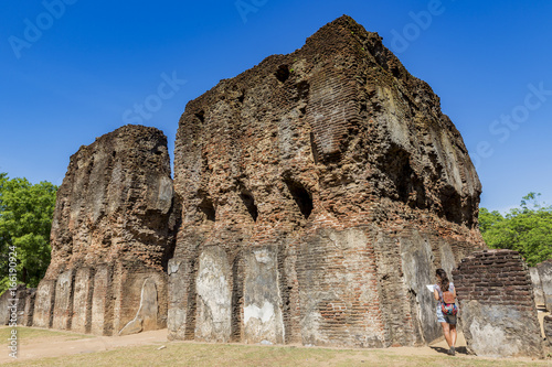 Girl contemplating the beautiful ruins of the Royal Palace and the ancient city of Polonnaruwa, Sri Lanka.