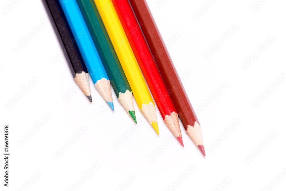 Six colored pencils on a white background. Dark blue, blue, green, yellow, red and brown. Bright colors. Back to school. Stationery. Six colored pencils on a white background. Dark blue, blue, green, yellow, red and brown. Bright colors. Back to school. Stationery.
