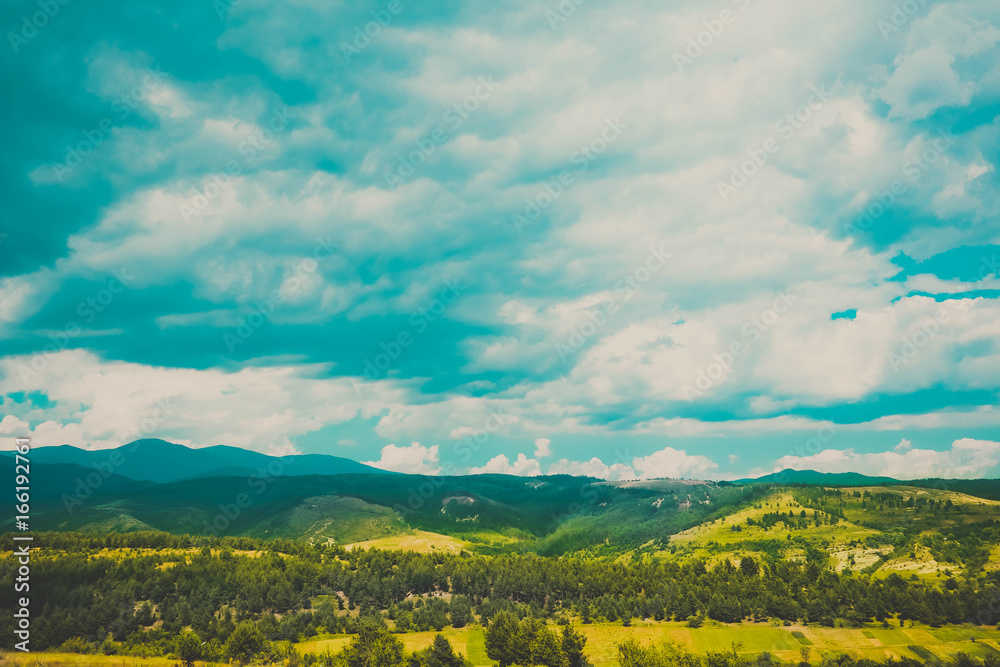 Photo depicting a beautiful colorful amazing mountain meadow paradise landscape, summertime. European alpine mountains in sunshine on a blue sky background.