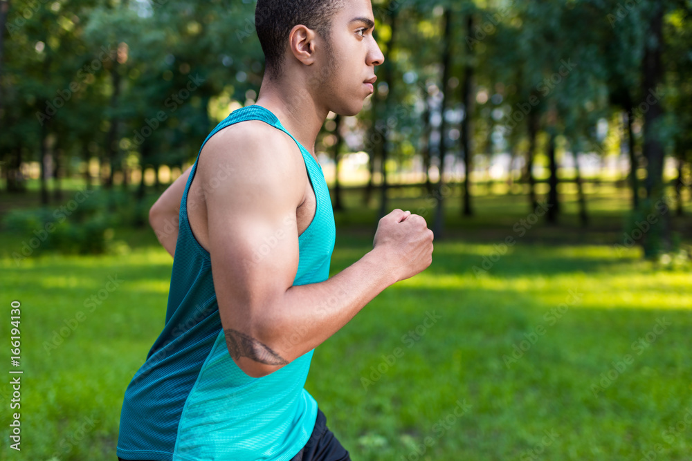 african american sportsman running in park african american sportsman running in park