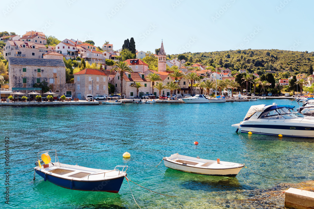 Boats moored in the harbor of a small town Splitska - Croatia, island Brac Boats moored in the harbor of a small town Splitska - Croatia, island Brac