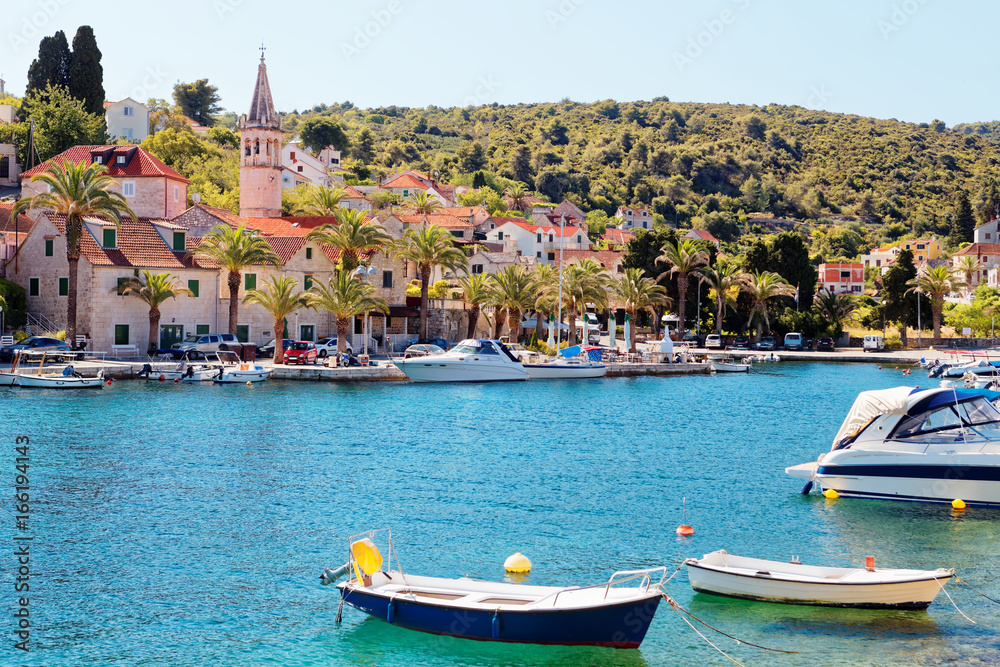 Moored boats in the harbor of a small town Splitska - Croatia, island Brac