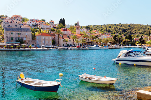 Boats moored in the harbor of a small town Splitska - Croatia, island Brac