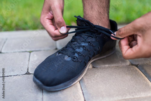 sportsman tying shoelaces