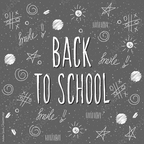 Back to school. Hand drawn lettering and doodle chalk elements on classroom chalkboard