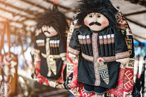 Souvenir bag decorated with a traditionally dressed georgian toy