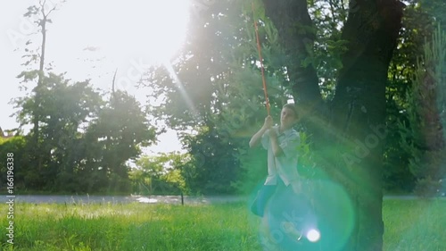 Playing on the swing at the sunset