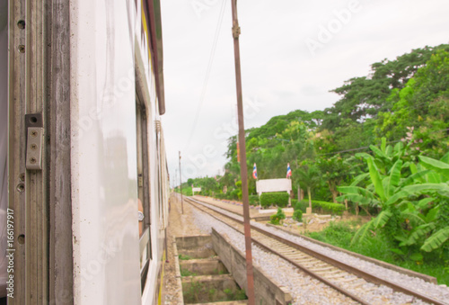 window old of train run travel  in countryside. select focus with shallow depth of field and  blurred background
