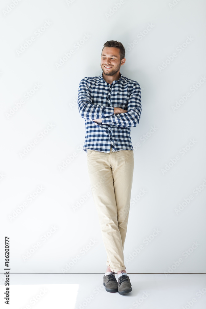 Confident handsome man with arms crossed on white wall background Confident handsome man with arms crossed on white wall background