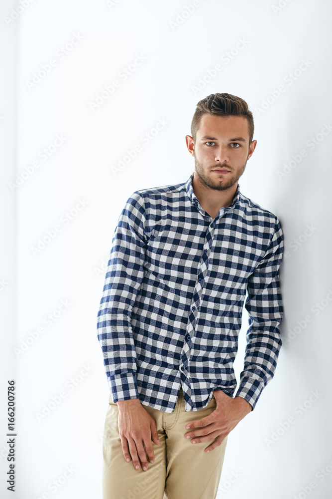 Handsome sexy man in stylish casual clothes leaning at wall Handsome sexy man in stylish casual clothes leaning at wall