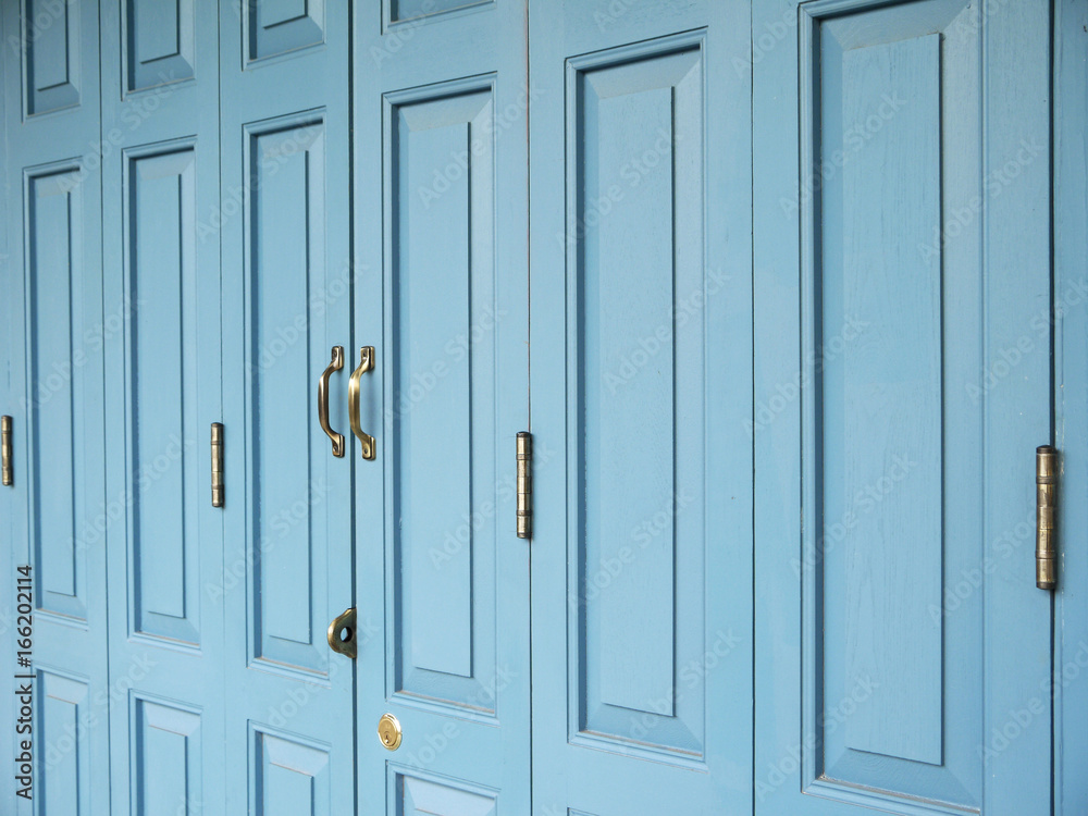 Fototapeta premium Old Door handles with an old double door painted with blue