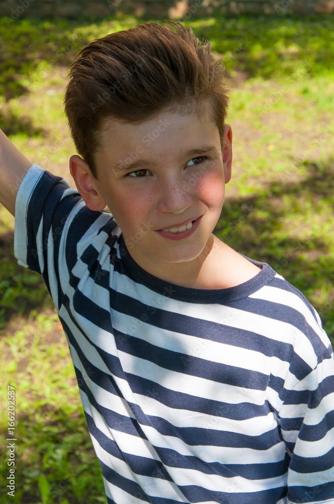 young smiling boy with a fashionable hairstyle on the walk young smiling boy with a fashionable hairstyle on the walk