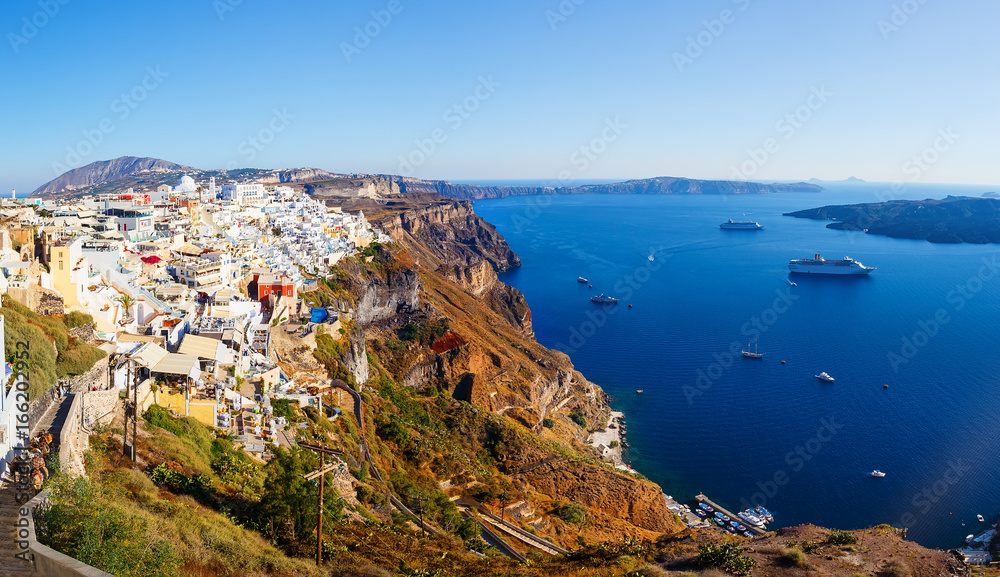 View of Fira village built on top of volcano cliff and blue sea Santorini island, Greece, Europe