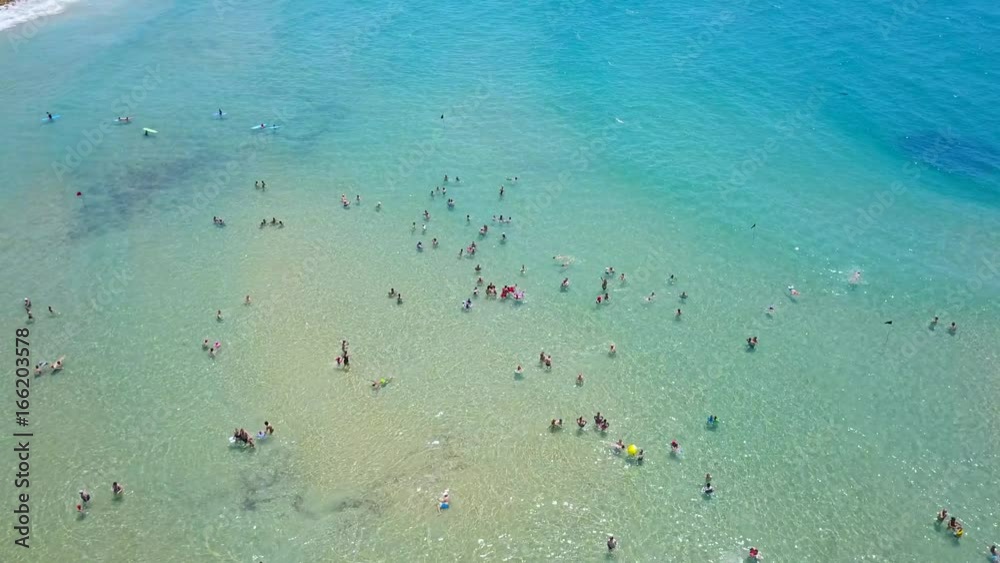Crowd of people enjoying the cool mediterranean sea - Aerial footage